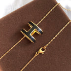 GlowHM CLIC BLACK ENAMEL GOLD NECKLACE